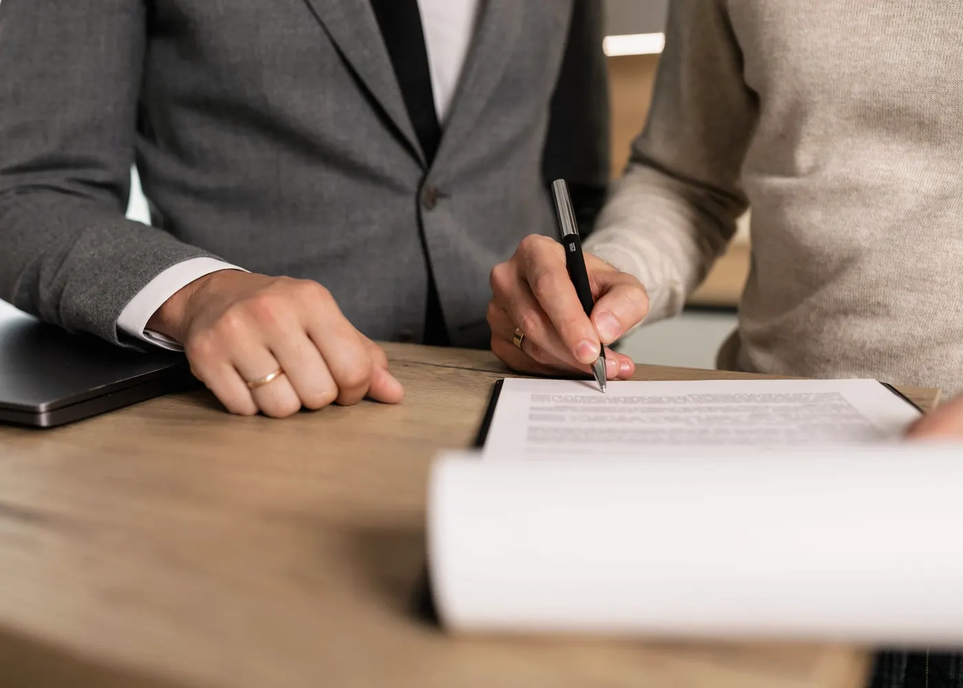 Signing papers at a solicitor's desk